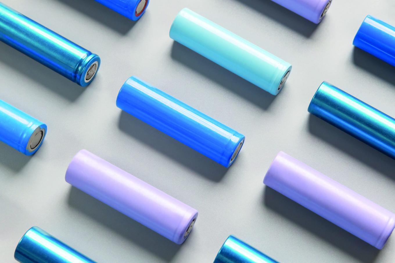 Close-up of colourful used rechargeable Nickel Metal Hydride (Ni-MH) battery on grey background