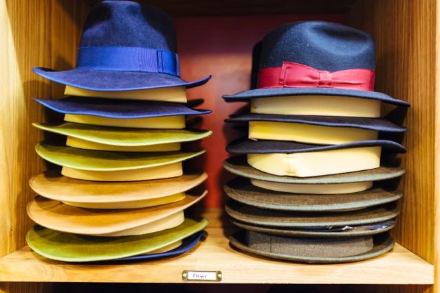 A stack of hats on a shelf
