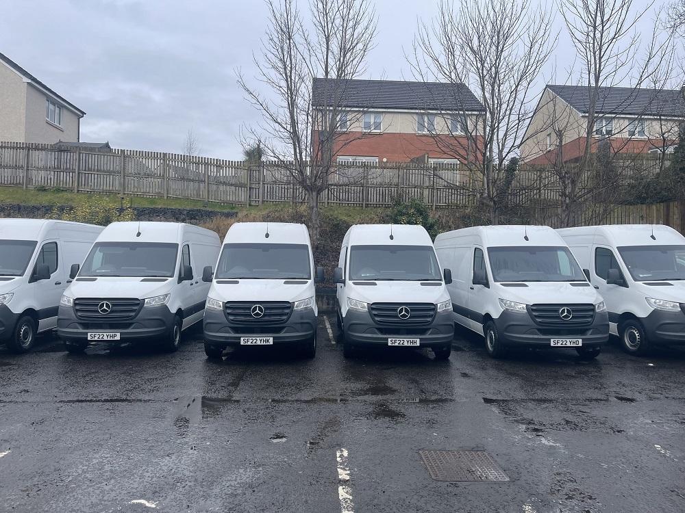 A fleet of commercial white vans